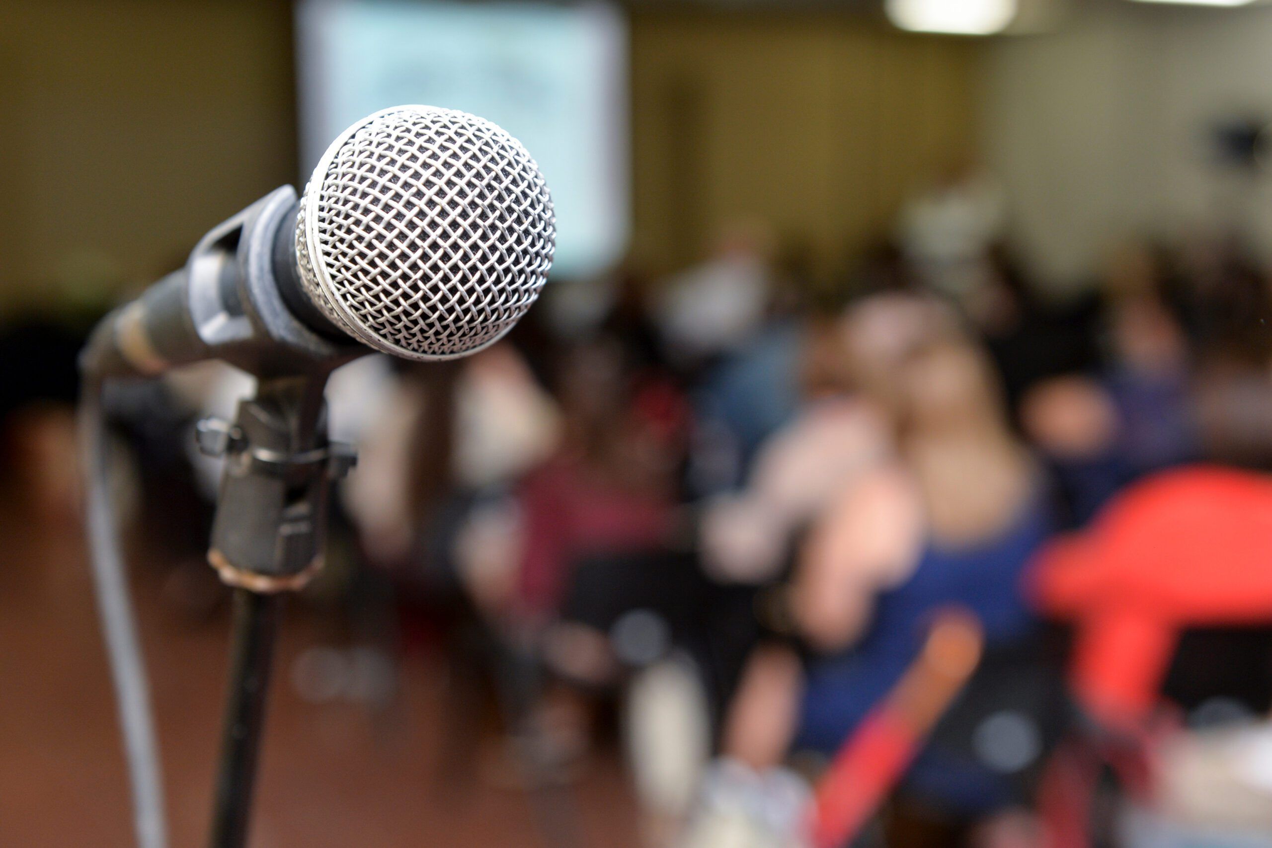 microphone with a blurred background audience